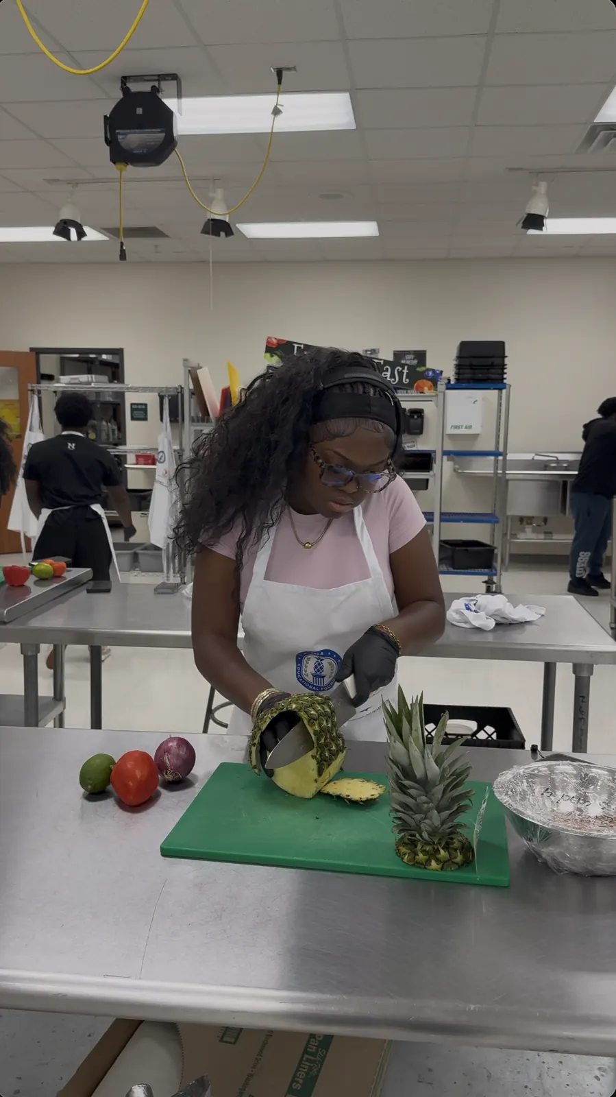 A student cutting pineapple in the lab