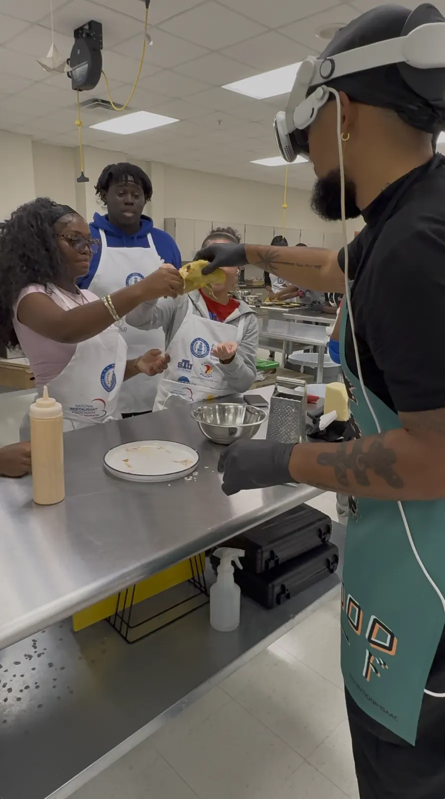 Chef Isaac teaching students at the stove